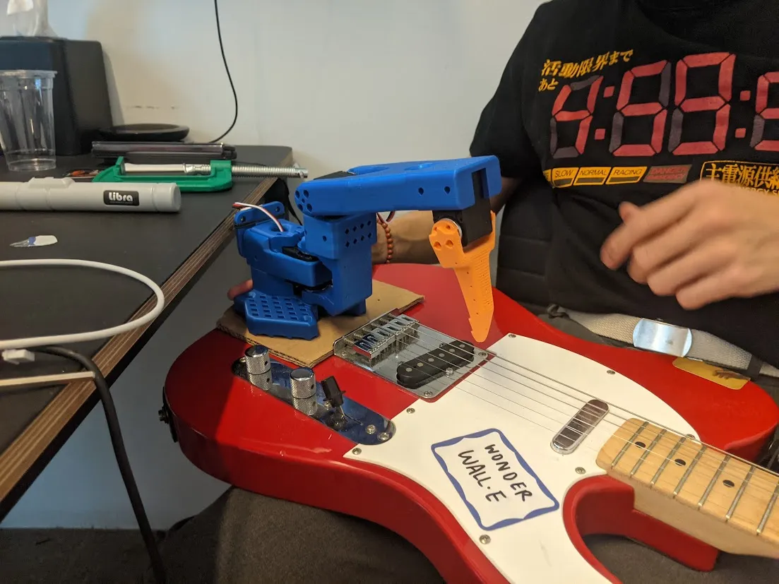 An early version of Wonderwalle, the guitar-playing robot arm.