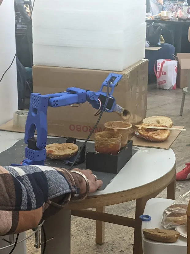 At the LeRobot Arm Hackathon there was a robot arm that could make peanut butter jelly sandwiches! So fire.